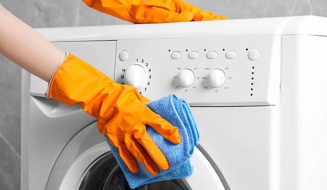 Image of homeowner wiping down the washer cabinet
