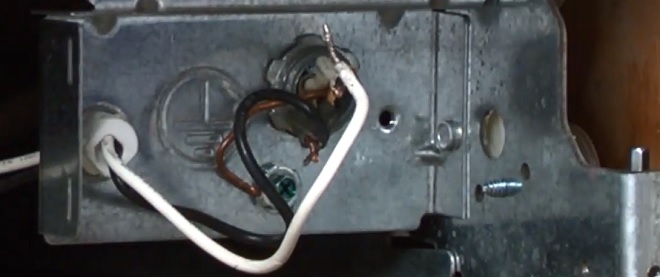 Image of installer connecting power cord wires on a dishwasher