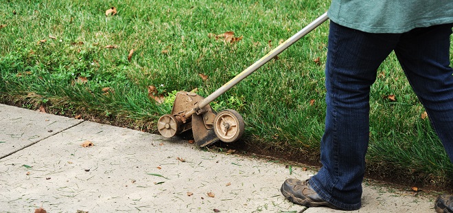 Image of man edging the lawn