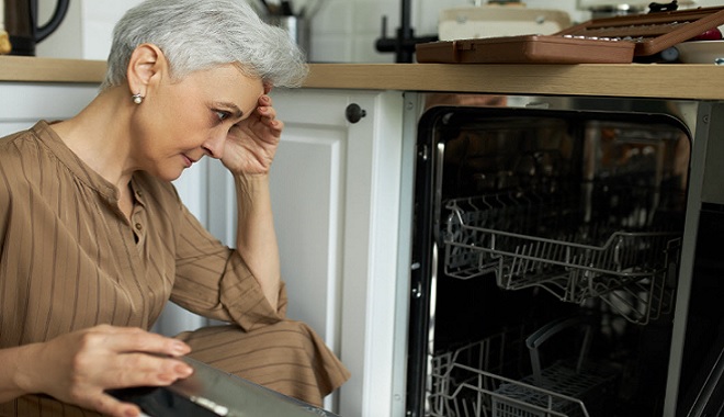 Image of homeowner encountering a dishwasher that needs professional repair