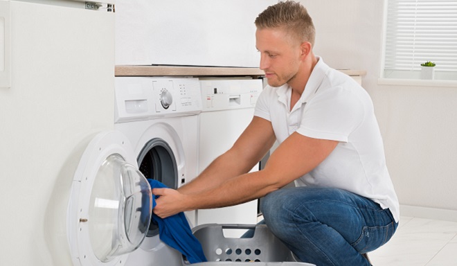 Image of homeowner loading the washer