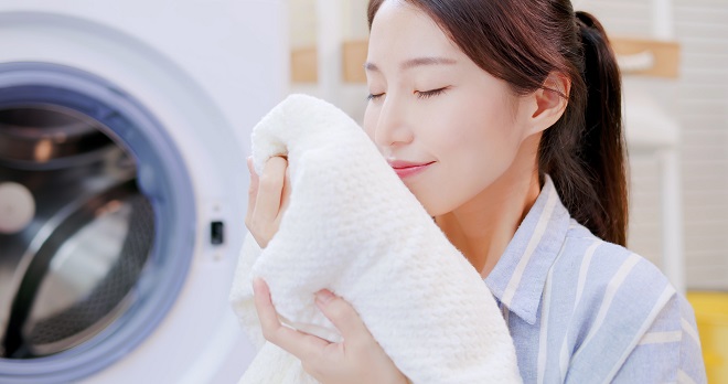 Image of woman enjoying a clean front load washer
