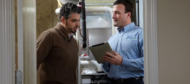 Image of Sears HVAC tech helping a customer