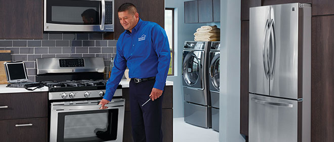 Image of Sears technician performing oven maintenance