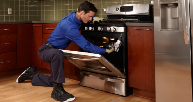 Image of Sears Home Services Technician performing oven maintenance