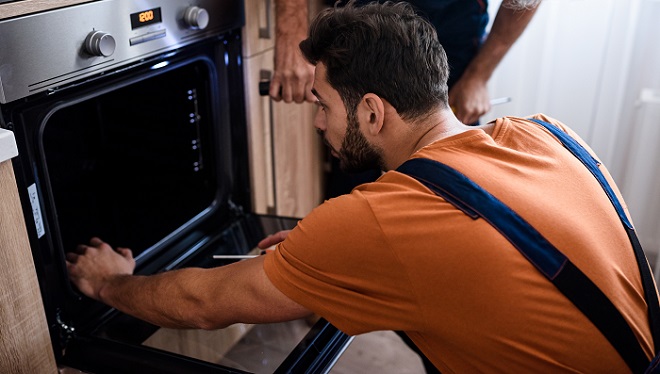 Image of homeowner removing the oven door seal