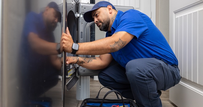 Image of a service technician working in a home