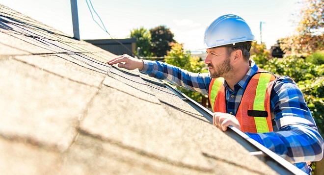 Image of Sears Home Services Roofing Expert inspecting the roof