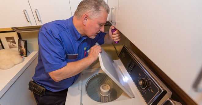 Image of Sears Home Services technician completing maintenance on a washing machine