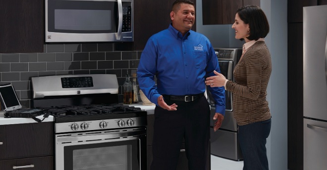 Sears Home Services Tech discussing oven maintenance with customer