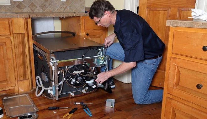 Image of an Sears Home Services Tech performing dishwasher repair