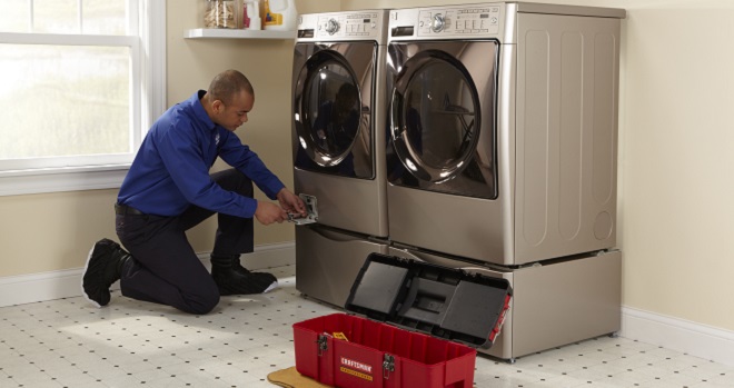 Image of Sears Technician maintaining a washing machine