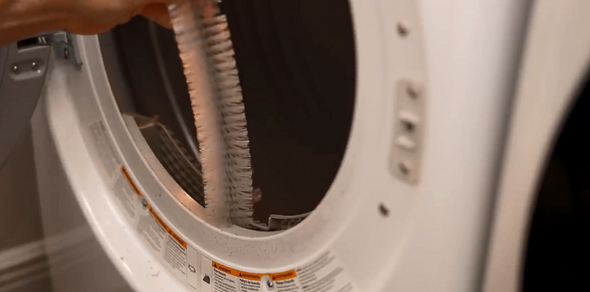 Image of a Sears Tech performing dryer maintenance