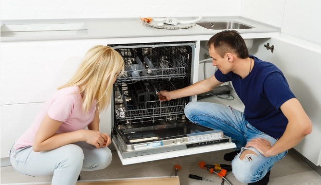 Homeowner installing a dishwasher