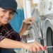 DIY'er fixing a washing machine image