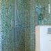 White bathroom with blue and green tiled shower