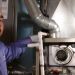 Sears technician performs preventive maintenance check on furnace