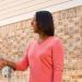 Sears HVAC expert shakes hands with woman in pink shirt in front of new AC units