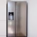 Stainless steel fridge in minimal, white kitchen
